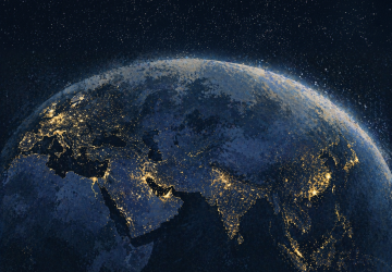 Global night-time view of Earth illustrating international financial connectivity and cross-border wealth movement.